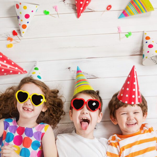 Happy,Child,Friend,In,Carnival,Party,,Lying,On,A,Wooden